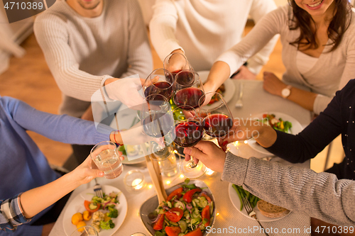 Image of happy family having dinner party at home