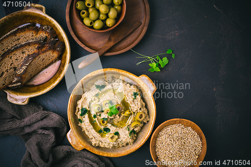 Image of Arabic Aubergine paste or dip Baba Ghanoush with olives and sesame seeds