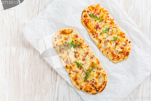 Image of Tarte Flambee - flat bread (Flammkuchen) with bacon, onion, champignon and cheese