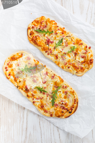 Image of Tarte Flambee - flat bread (Flammkuchen) with bacon, onion, champignon and cheese