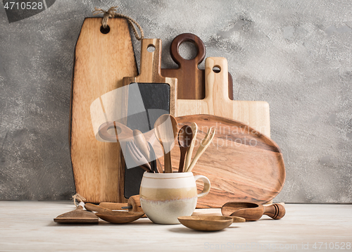 Image of Assortment of wooden cutting boards and kitchen utensils