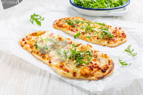 Image of Tarte Flambee - flat bread (Flammkuchen) with bacon, onion, champignon and cheese