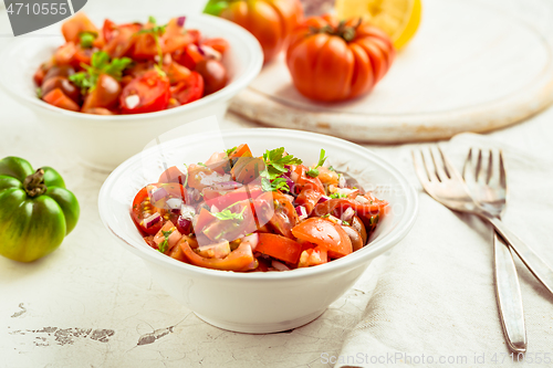 Image of Mexican Pico de Gallo with ingredients - tomato salad with onion, parsley, coriander