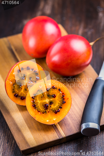 Image of Organic tamarillo (tree tomato) on cutting board