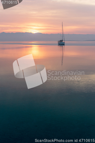 Image of Moored sailboat in the bay and sunrise