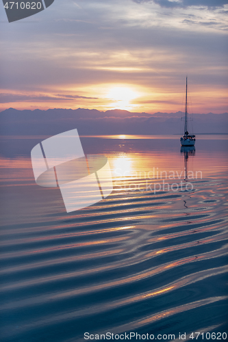 Image of Moored sailboat in the bay and sunrise