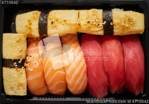 Image of Nigiri sushi set in plastic container ready for takeout delivery. Closeup of take away lunch box