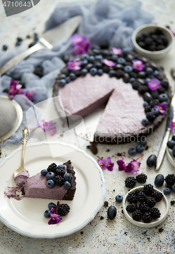 Image of Plate with homemade piece of delicious blueberry, blackberry and grape pie or tart served on table