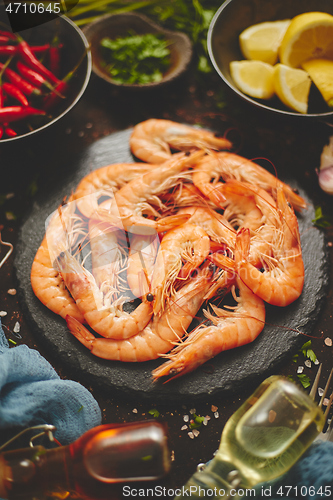 Image of Fresh and raw big shrimps ready to be prepared. With various ingredients on side