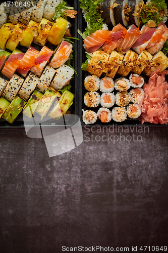 Image of Sushi take-away plastic tray with diffent kinds of rolls and copy space. Take-away food concept.