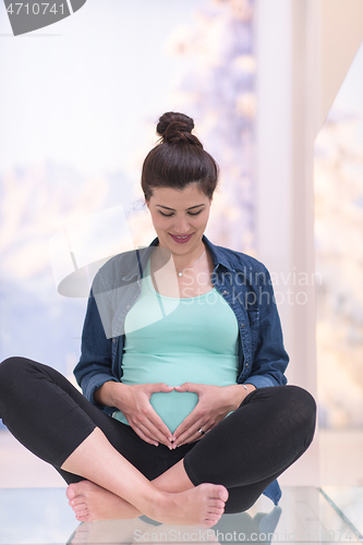 Image of pregnant women sitting on the floor