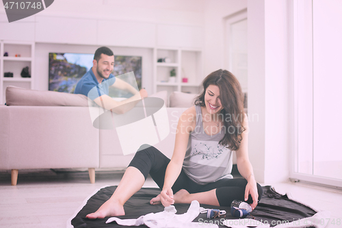 Image of pregnant couple checking a list of things for their unborn baby