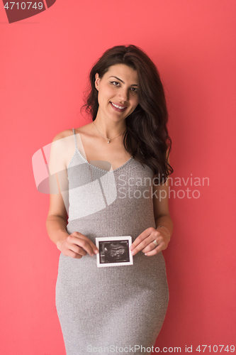 Image of happy pregnant woman showing ultrasound picture