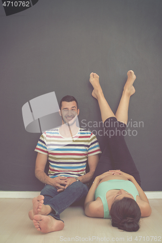 Image of pregnant couple relaxing on the floor