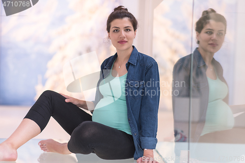 Image of pregnant women sitting on the floor