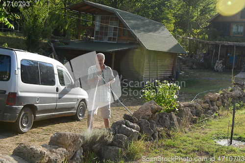 Image of gardener watering the plants