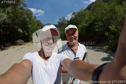 Image of dad and son taking selfie photos