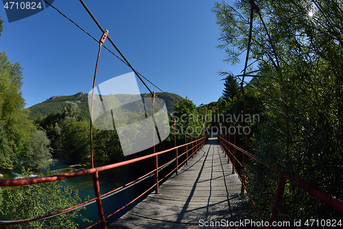 Image of wooden bridge over wild river