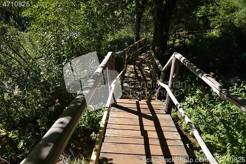 Image of wooden bridge over wild river