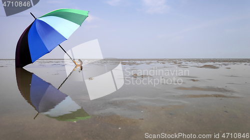 Image of Colorful umbrella and reflection