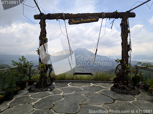 Image of Wooden swing on the rope with view of Batur volcano