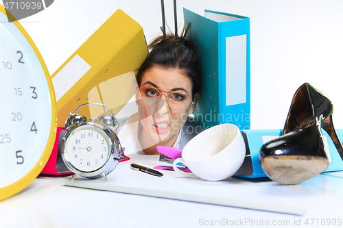 Image of Young woman getting a lot of work and deadline