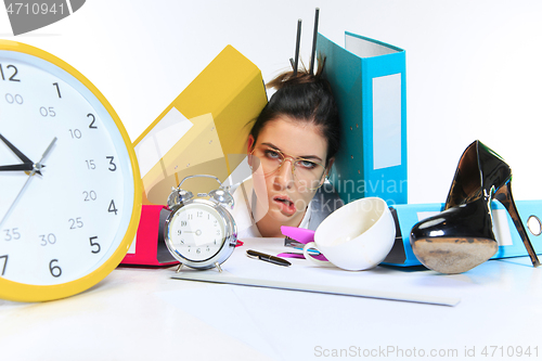 Image of Young woman getting a lot of work and deadline