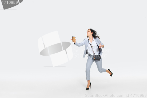 Image of Young woman comes late for work