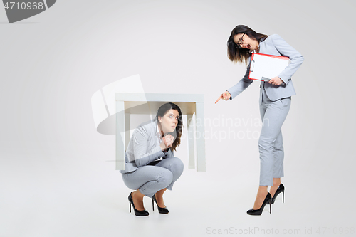 Image of Young woman under pressure from the colleague