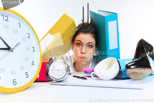 Image of Young woman getting a lot of work and deadline