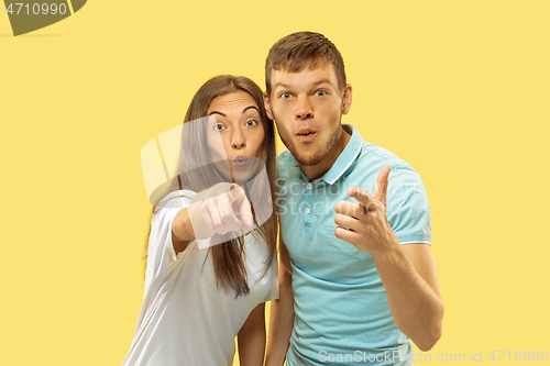 Image of Beautiful couple isolated on yellow studio background