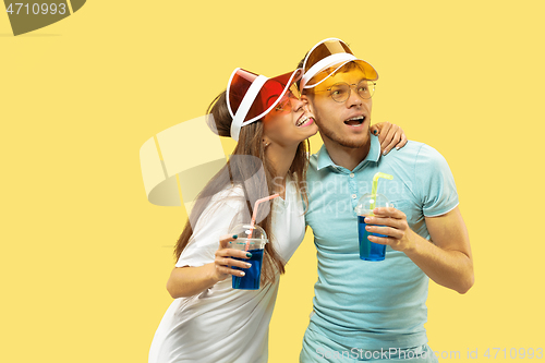 Image of Beautiful couple isolated on yellow studio background