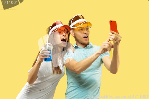 Image of Beautiful couple isolated on yellow studio background