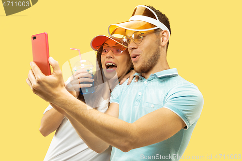 Image of Beautiful couple isolated on yellow studio background