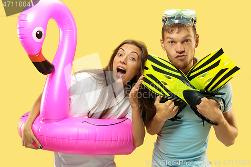 Image of Beautiful couple isolated on yellow studio background