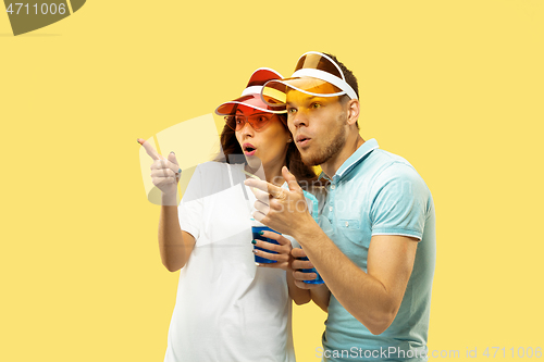 Image of Beautiful couple isolated on yellow studio background