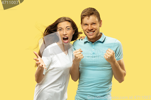 Image of Beautiful couple isolated on yellow studio background