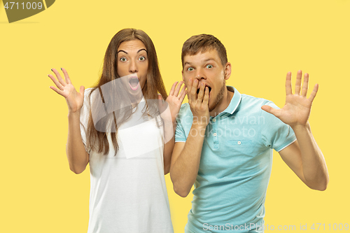 Image of Beautiful couple isolated on yellow studio background