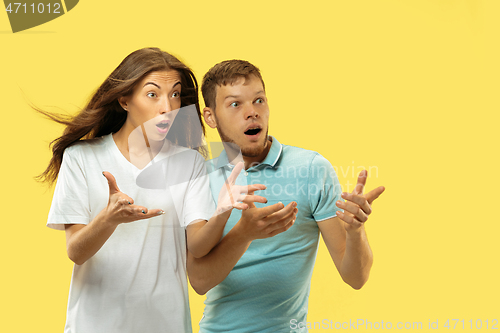 Image of Beautiful couple isolated on yellow studio background