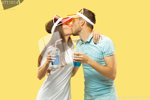 Image of Beautiful couple isolated on yellow studio background