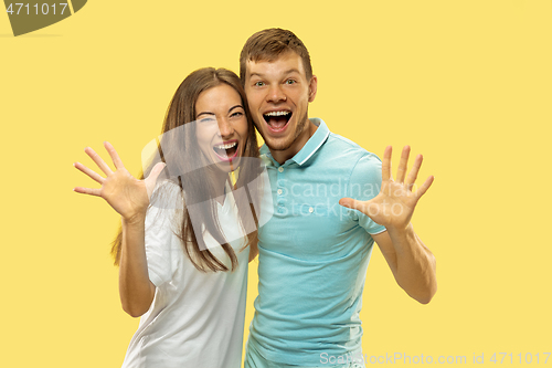 Image of Beautiful couple isolated on yellow studio background