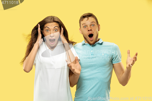 Image of Beautiful couple isolated on yellow studio background