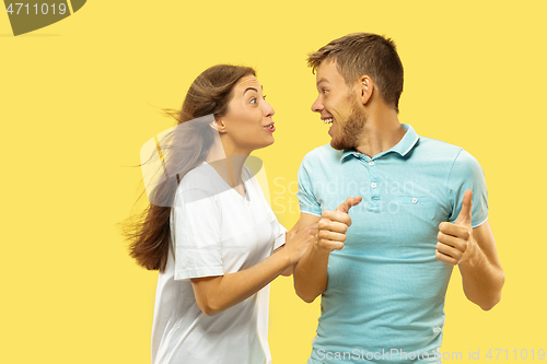 Image of Beautiful couple isolated on yellow studio background