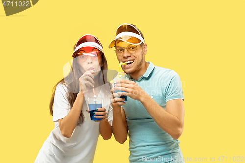 Image of Beautiful couple isolated on yellow studio background