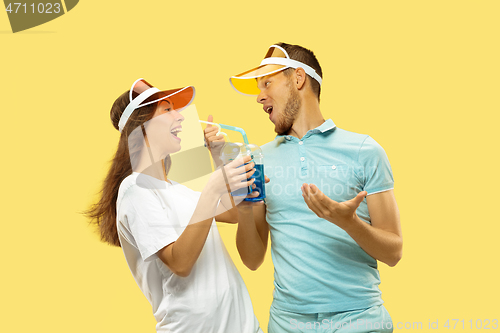 Image of Beautiful couple isolated on yellow studio background