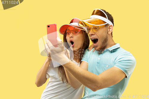 Image of Beautiful couple isolated on yellow studio background