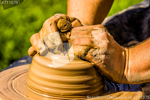 Image of Potters hands working on new project