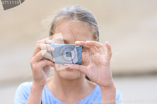 Image of Girl takes pictures with a digital camera