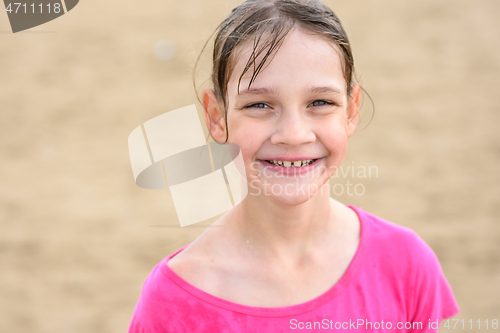 Image of Portrait of a happy ten year old girl with wet hair swimming in the sea