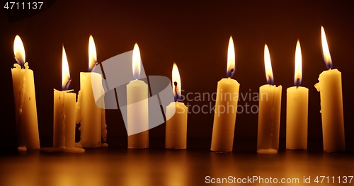 Image of Candles glowing against dark background